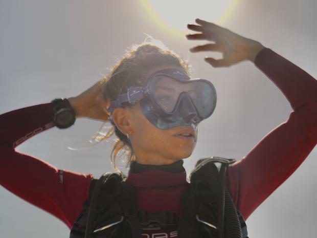 PADI AmbassaDiver Luciana Maldonado posing outside in her scuba diving gear.