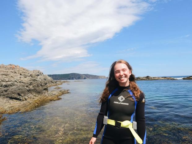 PADI AmbassaDiver Jillian Taylor posing in her scuba diving gear.